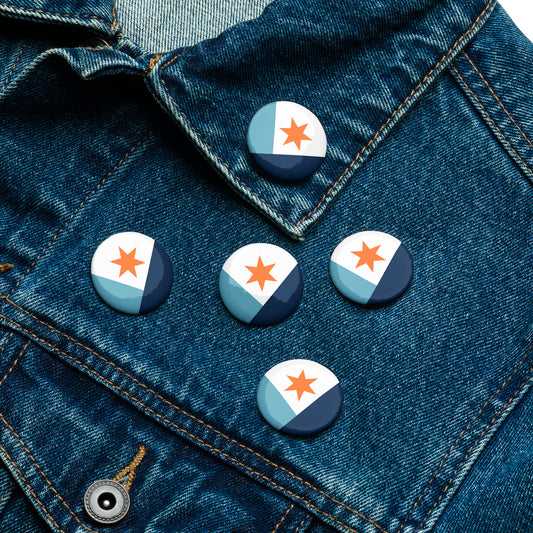 Five Syracuse, NY city flag button pins lying flat on a denim jacket