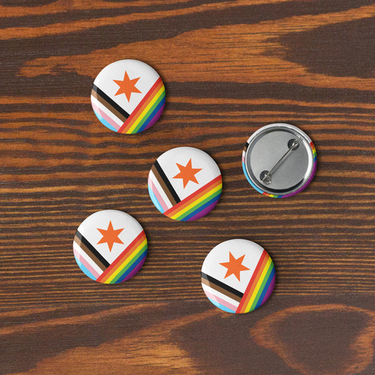 Five Pride version Syracuse, NY city flag button pins lying flat on a wooden surface
