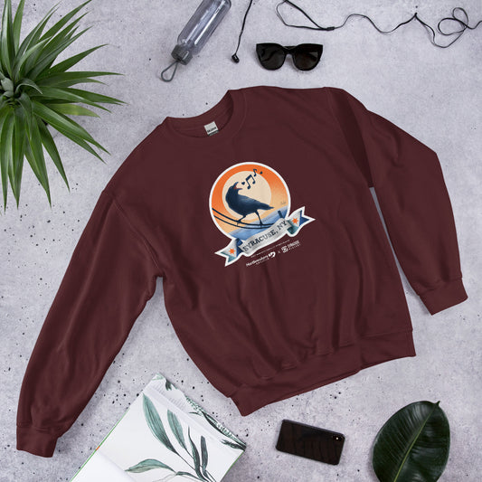 A maroon sweatshirt featuring an illustration of a crow on a telephone wire and a banner beneath it that says Syracuse, NY