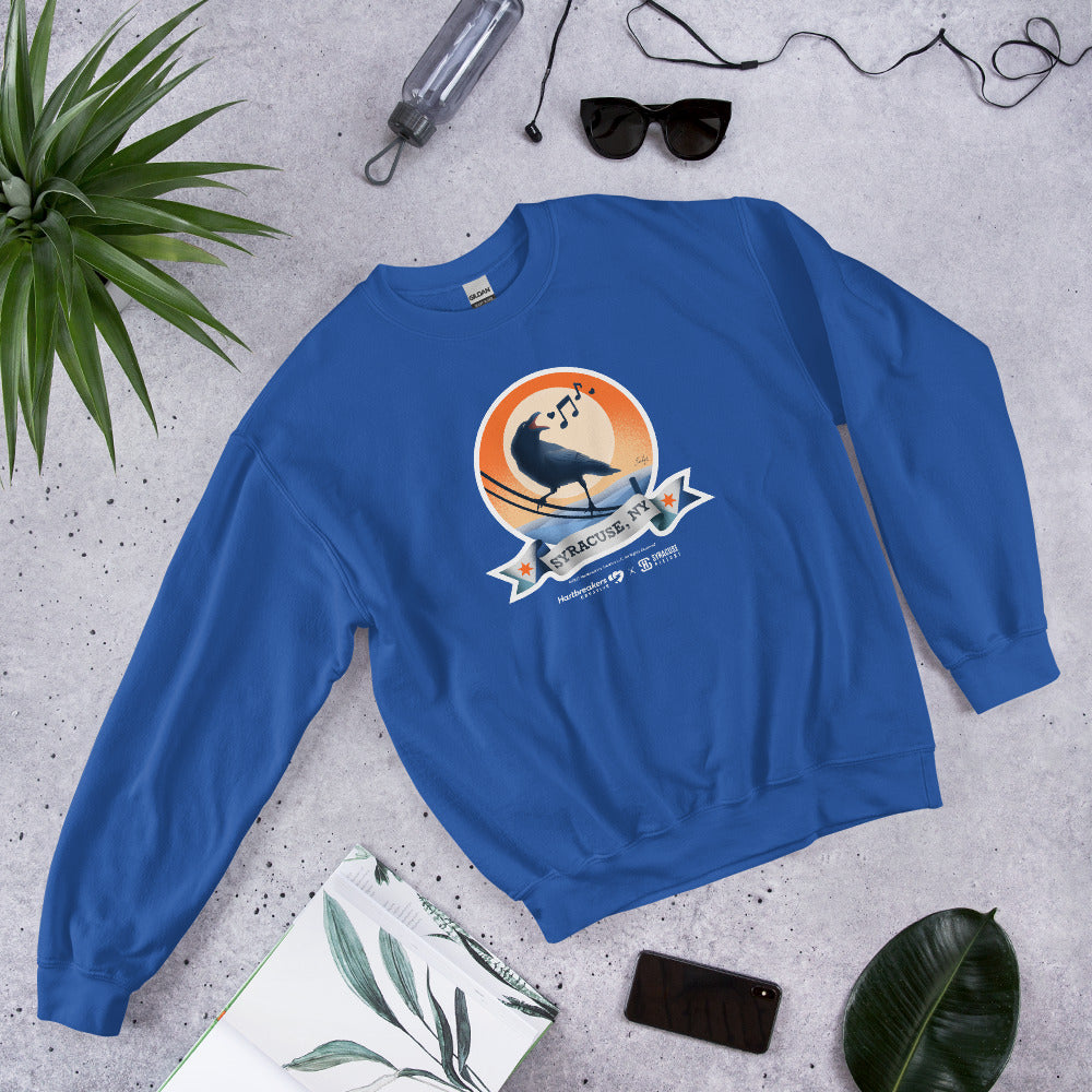 A royal blue sweatshirt featuring an illustration of a crow on a telephone wire and a banner beneath it that says Syracuse, NY