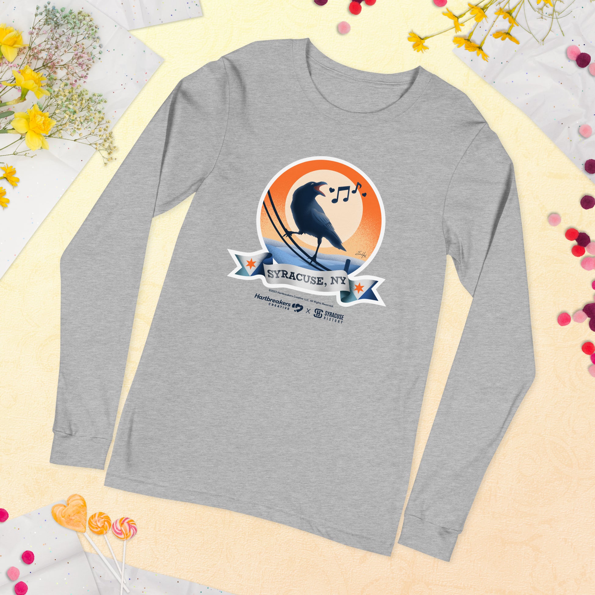 An athletic heather long sleeve T-shirt featuring an illustration of a crow on a telephone wire and a banner beneath it that says Syracuse, NY