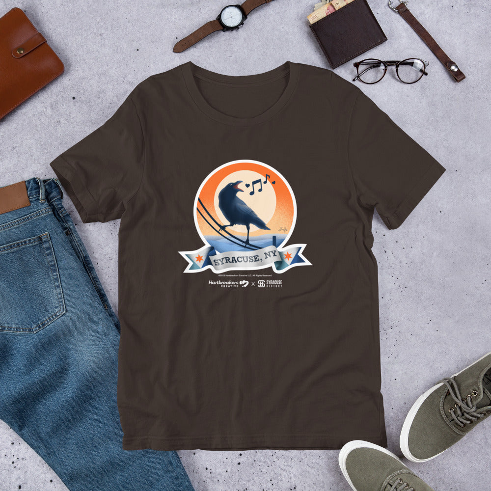 A brown T-shirt featuring an illustration of a crow on a telephone wire and a banner beneath it that says Syracuse, NY