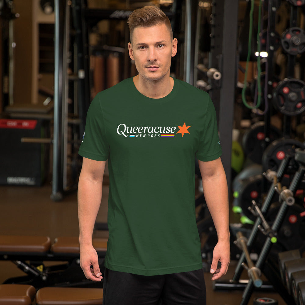 A man in a gym facing us wearing a forest green Syracuse, NY t-shirt featuring a Queeracuse logo