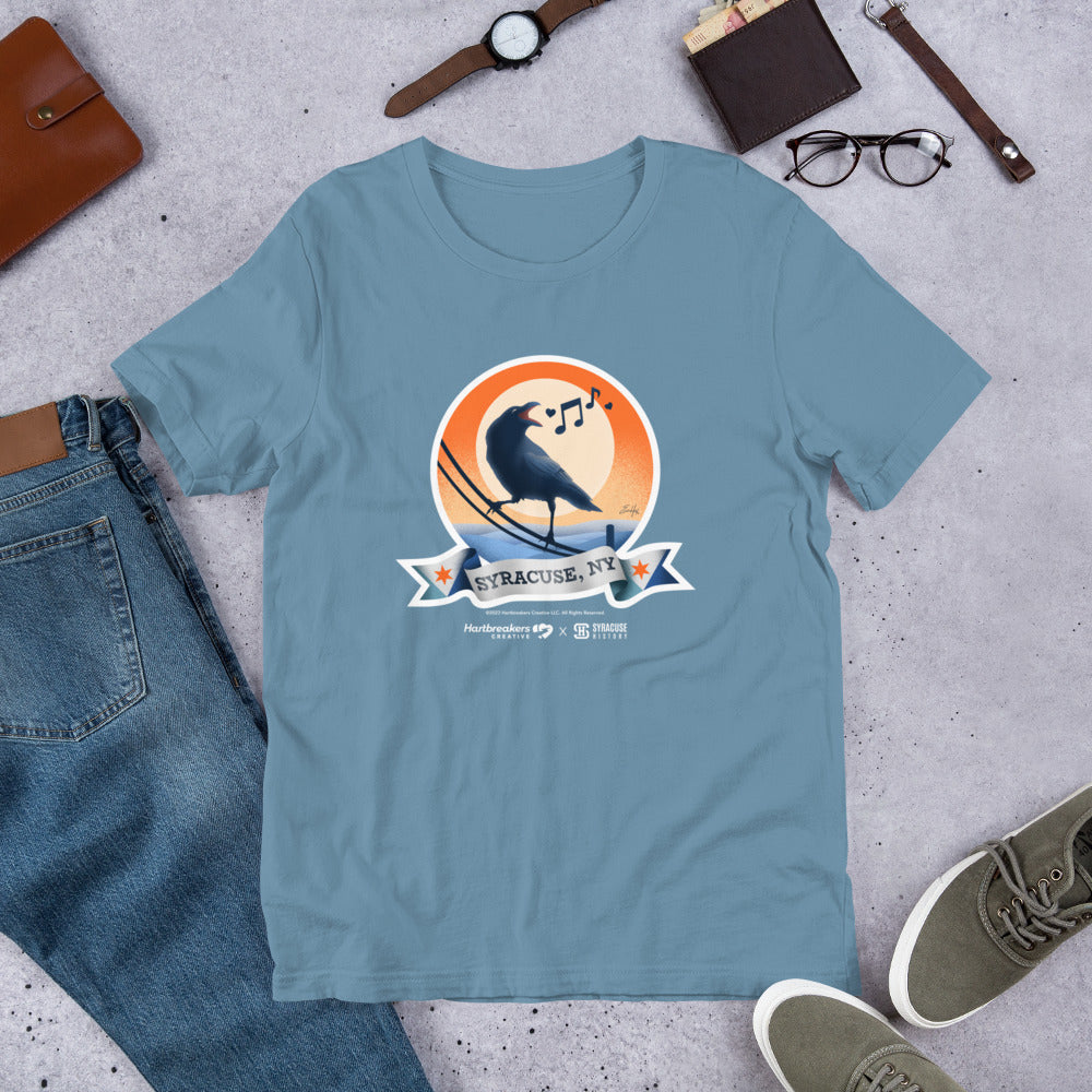A steel blue T-shirt featuring an illustration of a crow on a telephone wire and a banner beneath it that says Syracuse, NY
