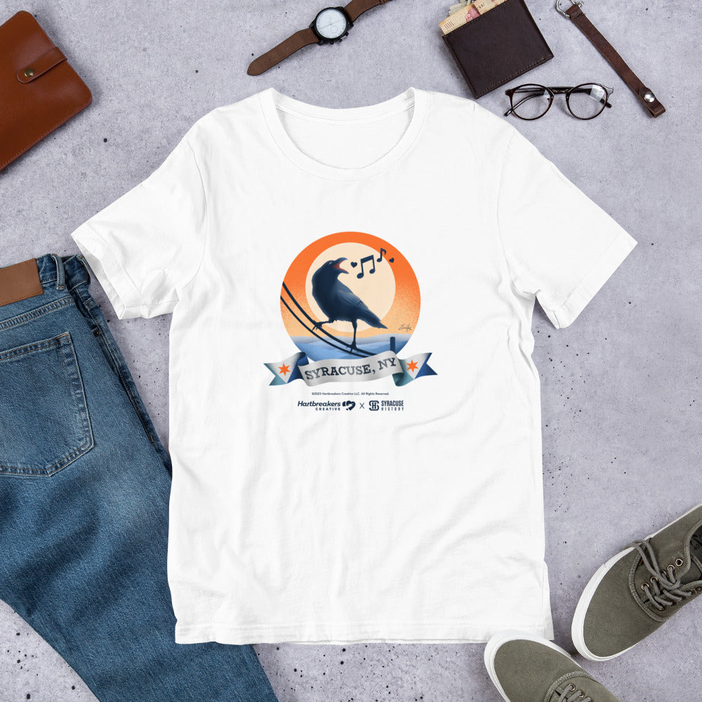 A white T-shirt featuring an illustration of a crow on a telephone wire and a banner beneath it that says Syracuse, NY