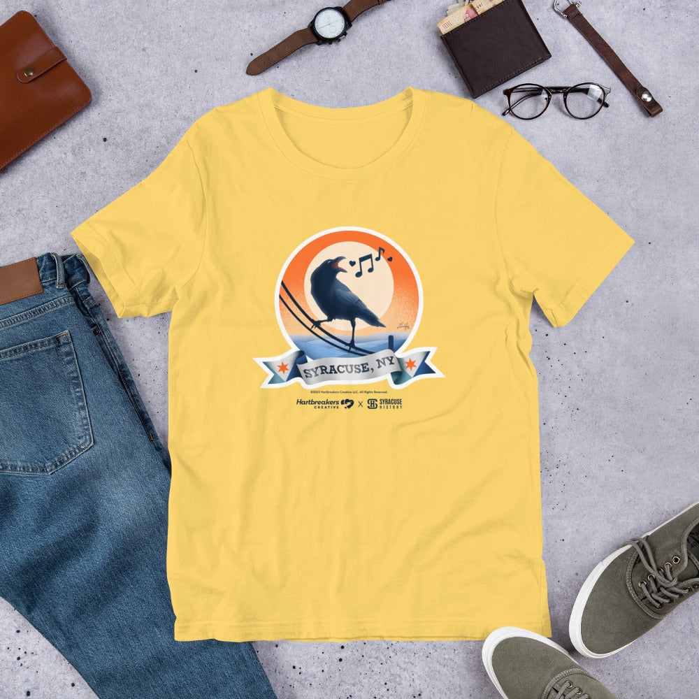 A yellow T-shirt featuring an illustration of a crow on a telephone wire and a banner beneath it that says Syracuse, NY